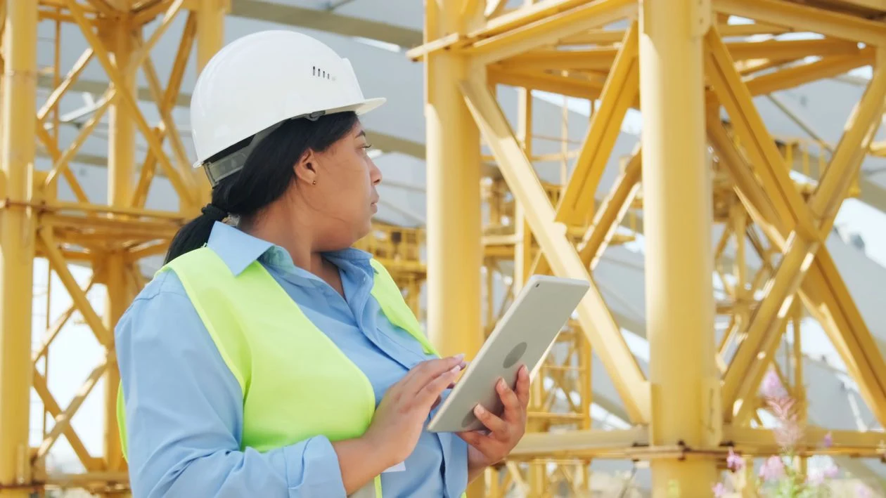 Construction colleagues reviewing a tablet on site