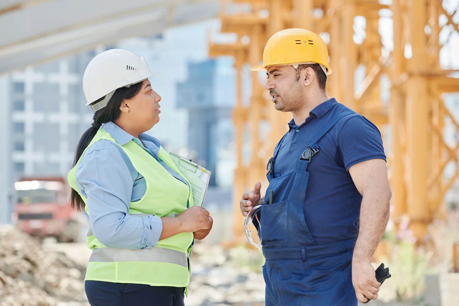 Two construction professionals discussing work together at a building site